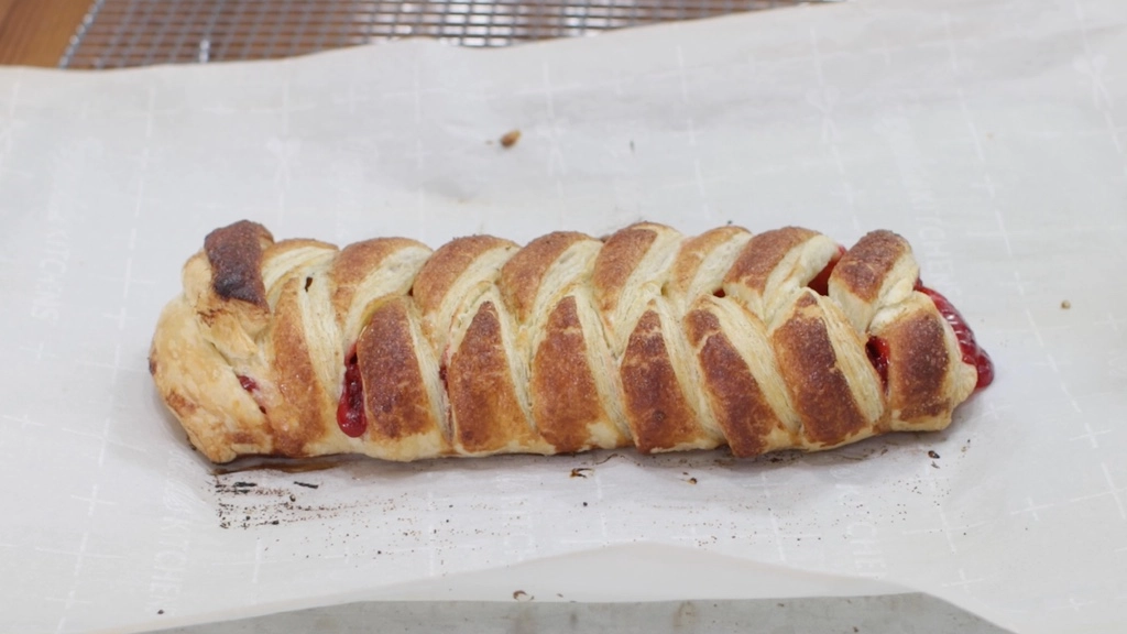 Freshly baked pastry on a sheet pan with parchment paper.