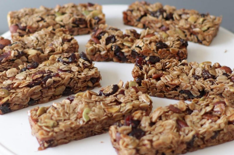 Several homemade granola bars on a white plate