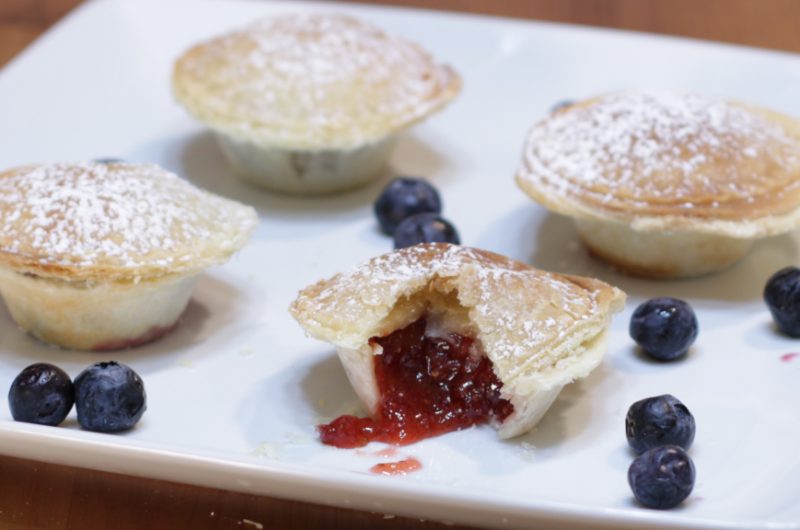 Four mini pies on a white plate