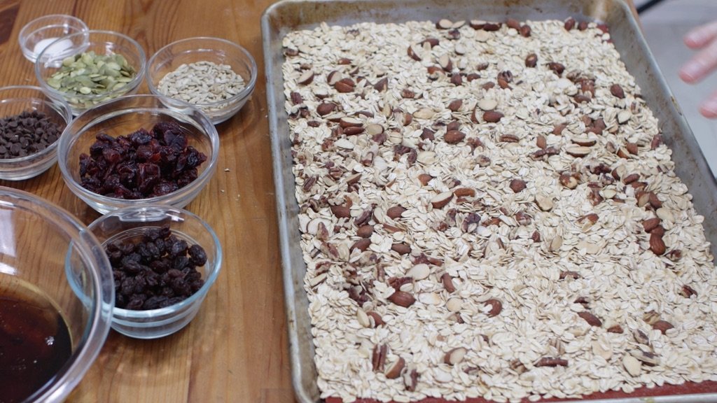 Sheet pan full of toasted oats, pecans, and almonds. 