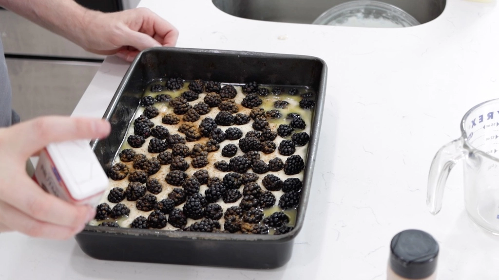 Unbaked blackberry cobbler in a pan on a white countertop