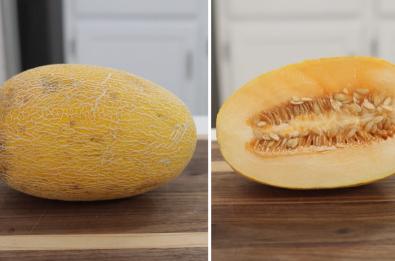 Hami melon cut in half on a cutting board