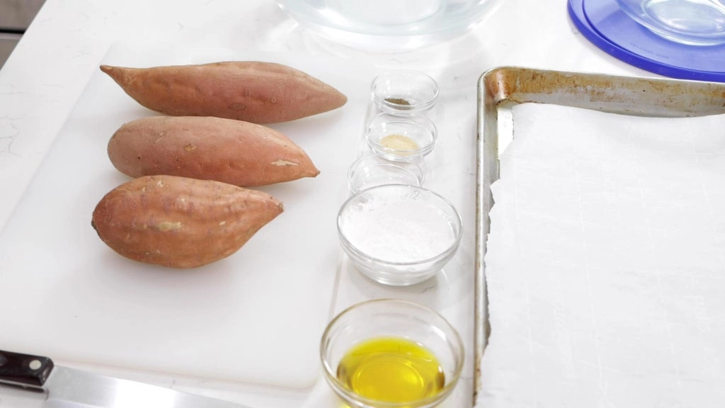 sweet potatoes and other ingredients in bowls on a white countertop.