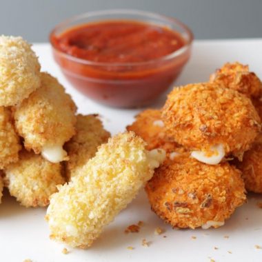 Piles of air fryer mozzarella sticks on a plate