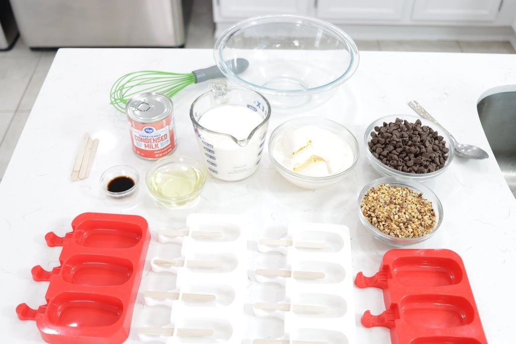 Ice Cream Bars Recipe | 5 Ingredients - In The Kitchen With Matt 1 Several ingredients in glass bowls on a white counter top.