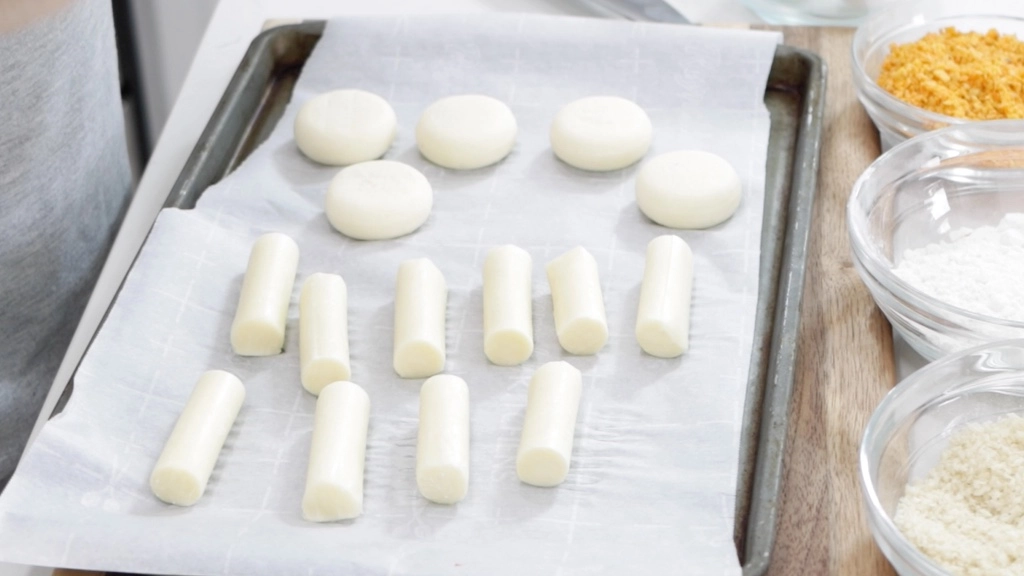 Mozzarella cheese pieces on a sheet pan.