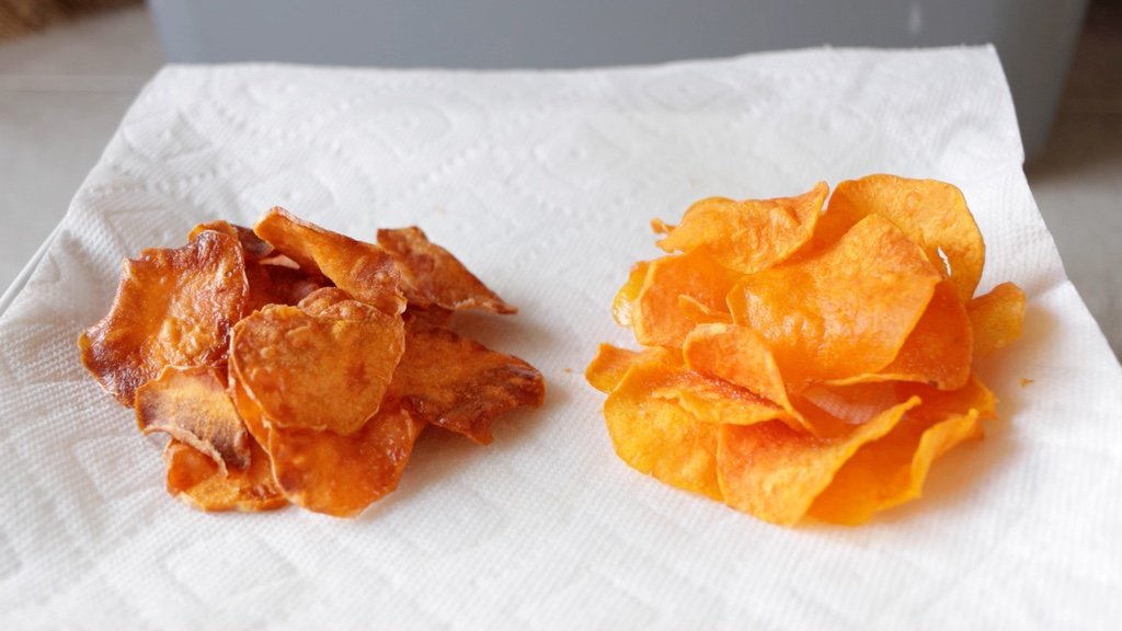 Two piles of sweet potato chips on a plate.
