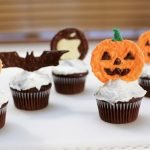 Halloween cupcake toppers on chocolate cupcakes.