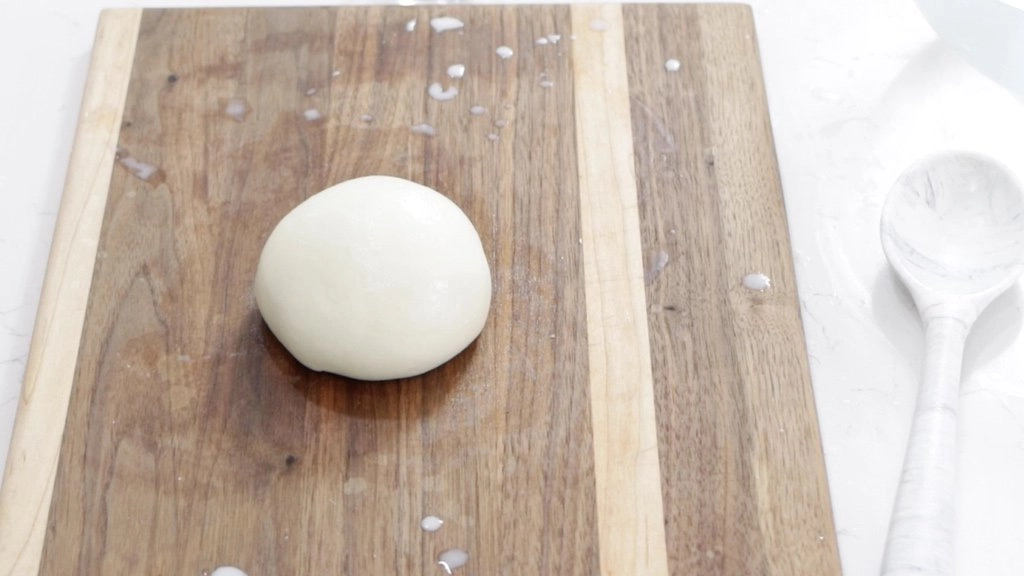 Ball of fresh homemade mozzarella cheese made from milk powder.
