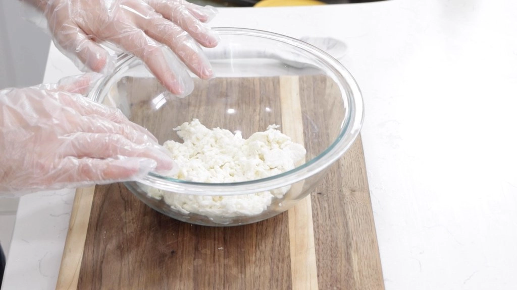 Cheese curds in a medium glass bowl.