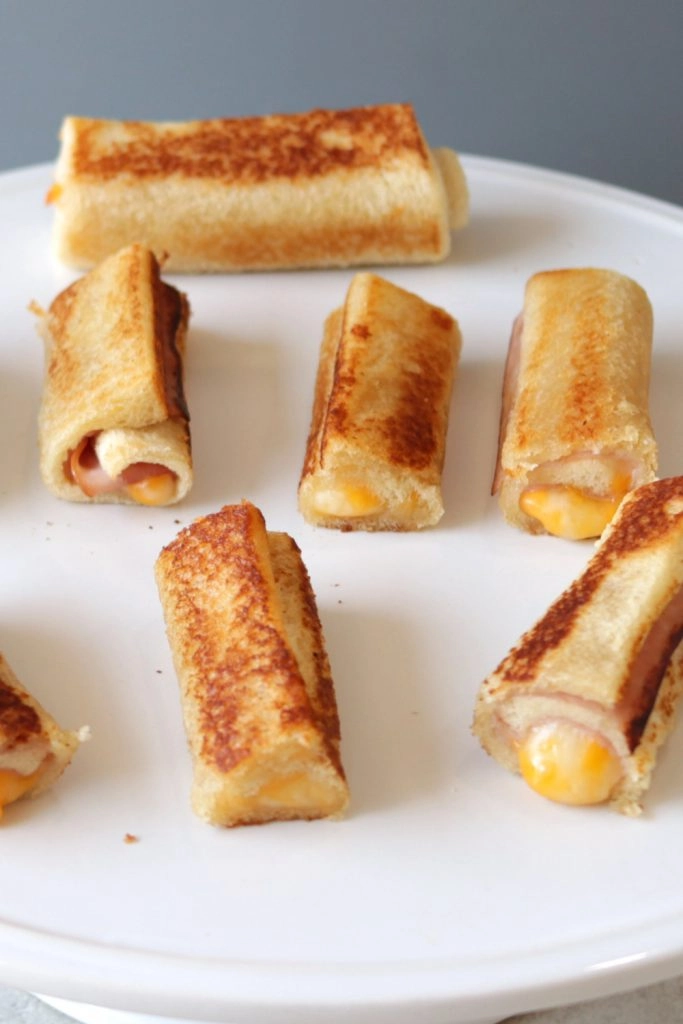 Grilled cheese roll ups on a white plate. Grilled cheese roll ups on a white plate.