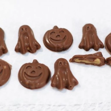 several Halloween peanut cups on a white cutting board