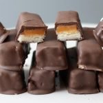 Stack of homemade Twix bars on a white plate