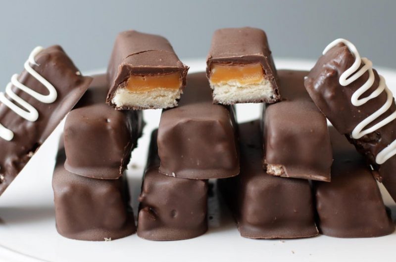 Stack of homemade Twix bars on a white plate