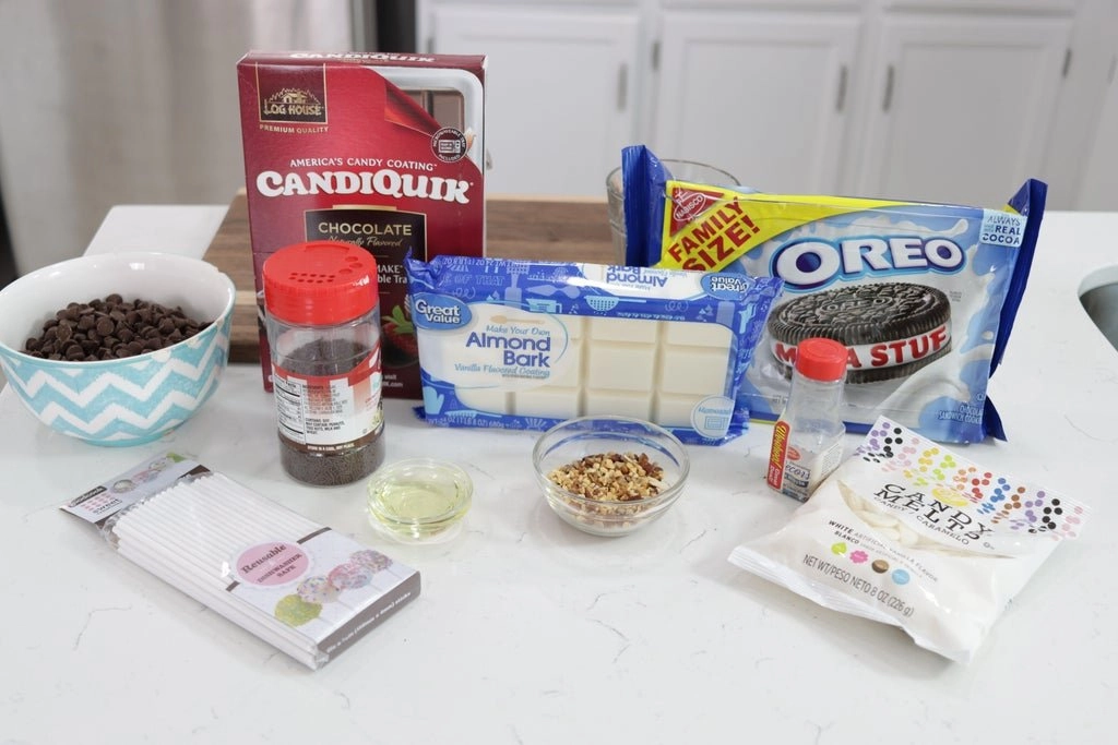 Several ingredients on a counter top including chocolate, nuts, Oreos, etc.
