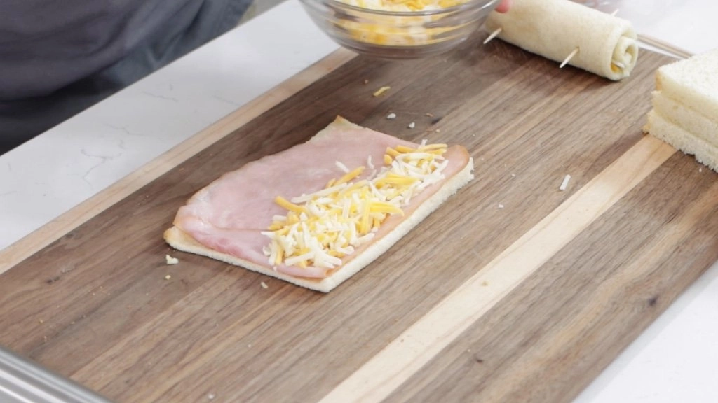 Ham and cheese on top of a slice of bread.