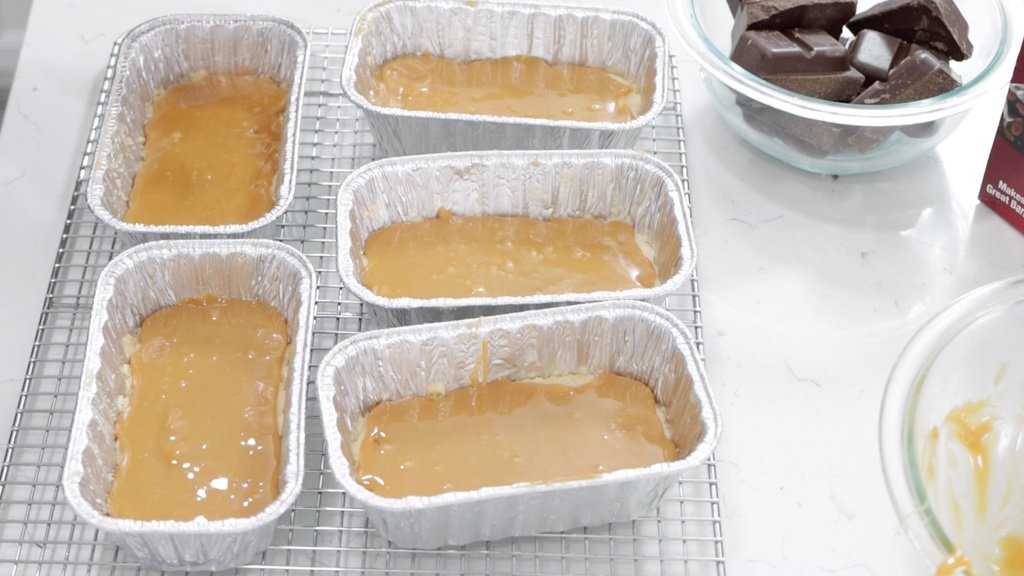 Caramel on top of shortbread cookie base for homemade Twix bars