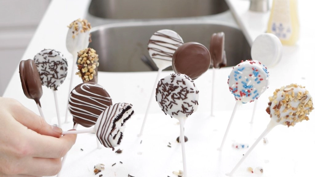 Oreo pops in styrofoam and one with a bite out of it.