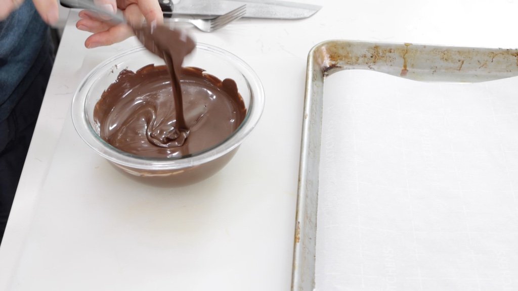 Bowl of melted CandiQuik chocolate for homemade Twix bars