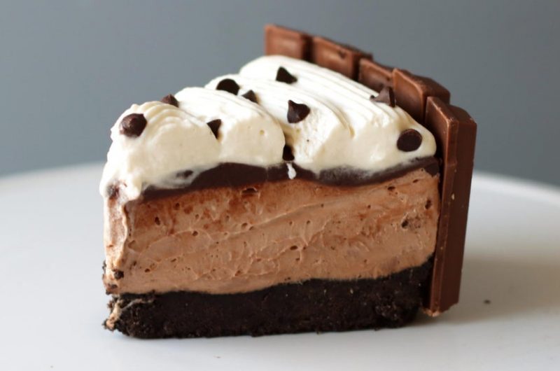 Slice of no-bake chocolate cheesecake on a white plate