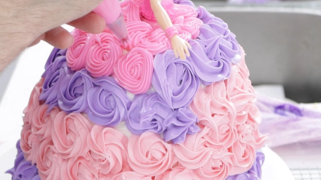 Adding neon pink frosting flowers