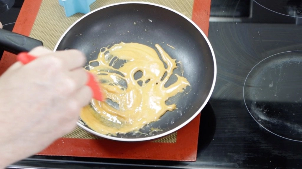 Melted Squid Game Dalgona candy in a skillet
