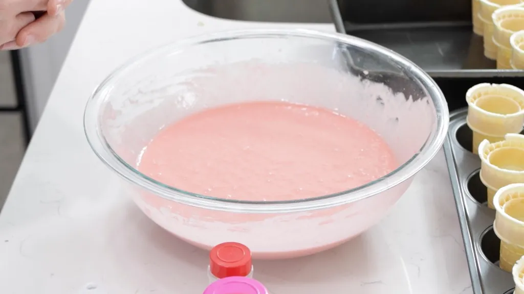 Large bowl with strawberry cake batter.