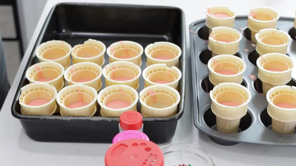 Cake batter in several ice cream cones.