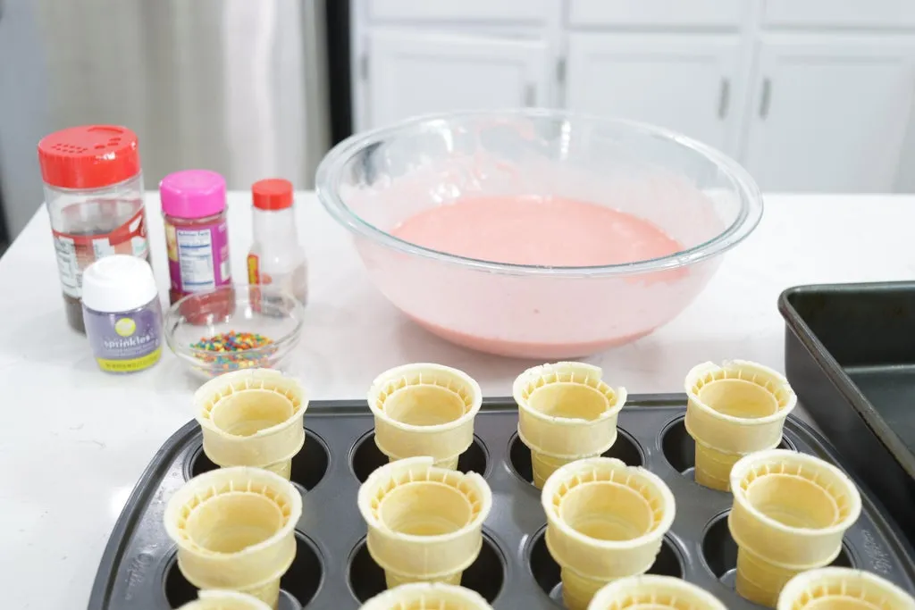 Strawberry cake batter in a large bowl on a white countertop.