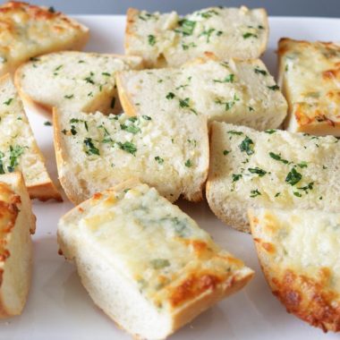 White plate full of homemade garlic bread