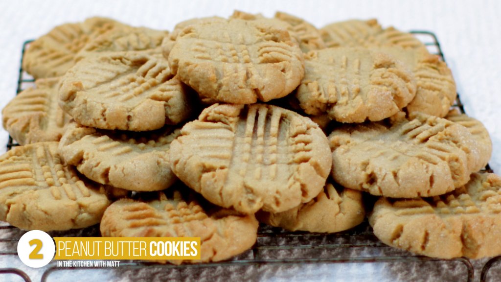 pile of soft chewy peanut butter cookies on a wire cookie rack