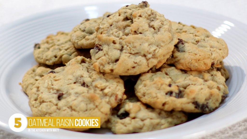 Pile of oatmeal raisin cookies on a white plate, number 5 on the top 10 cookie recipes list.