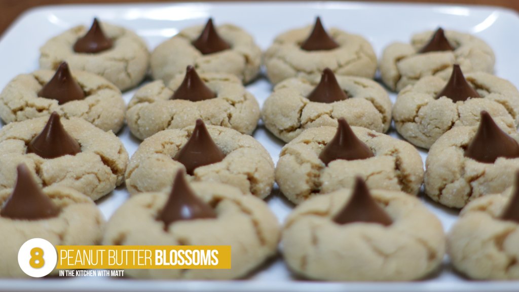 Peanut butter blossoms on a white plate.