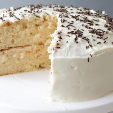 Best homemade vanilla cake recipe on a white cake pedestal