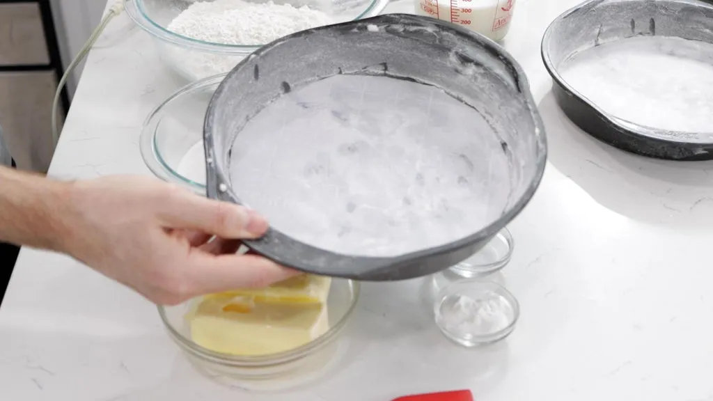 Greased and floured cake pan with parchment paper on the bottom.