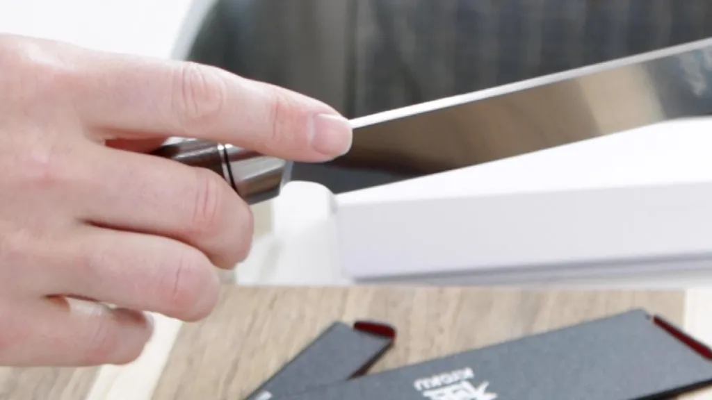 Index finger touching the top of the blade of a Kyoku Nakiri knife.