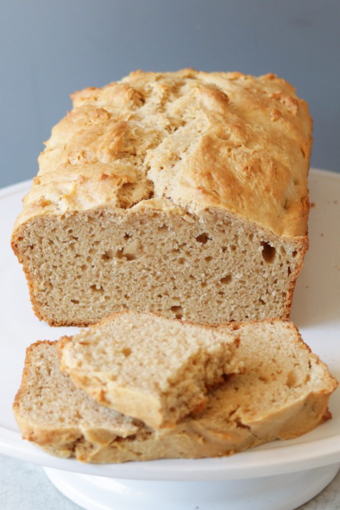 Loaf of peanut butter bread on a white plate.