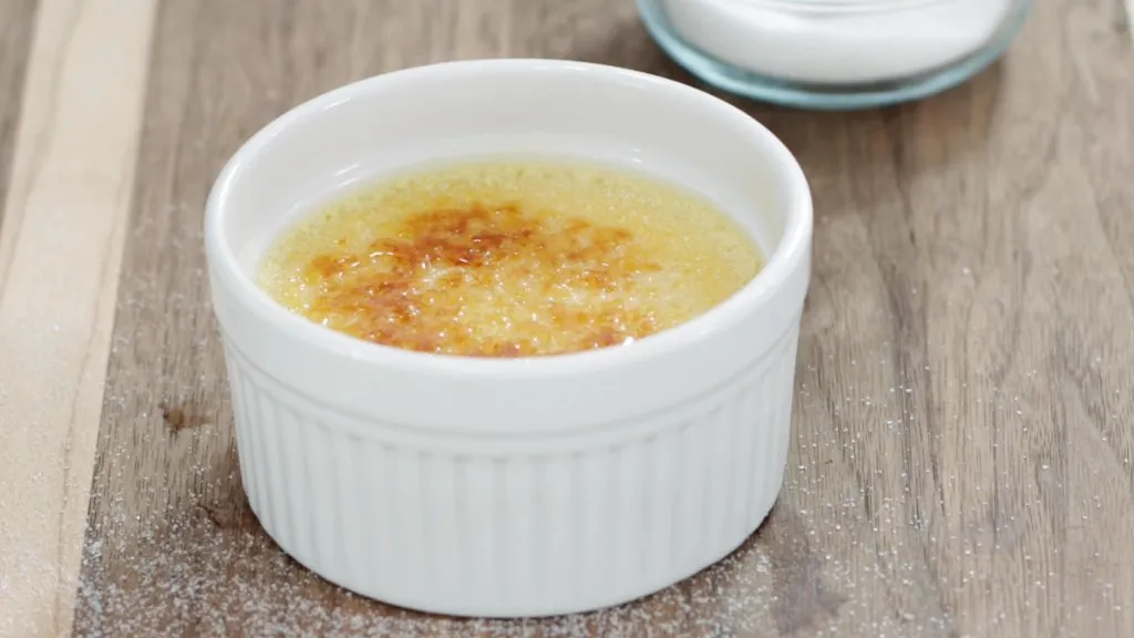 Finished creme brulee on a cutting board.