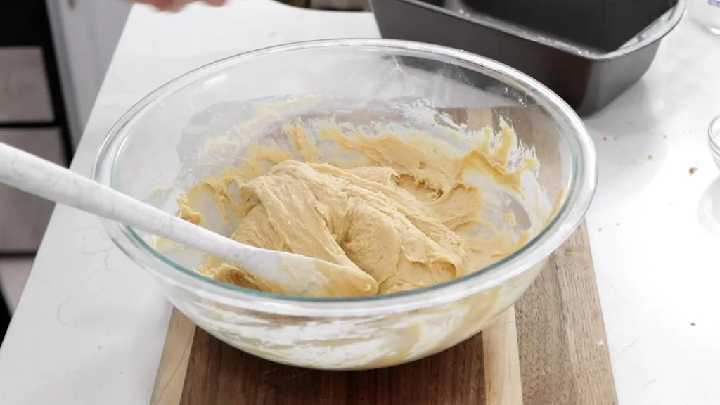 Large glass bowl filled with peanut butter bread batter.