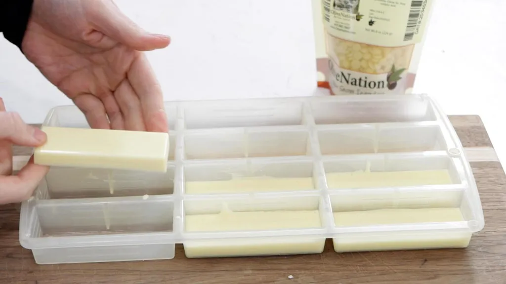 Hand holding a homemade white chocolate bar.