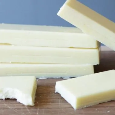 how to make white chocolate with 3 ingredients stacks of white chocolate on cutting board.