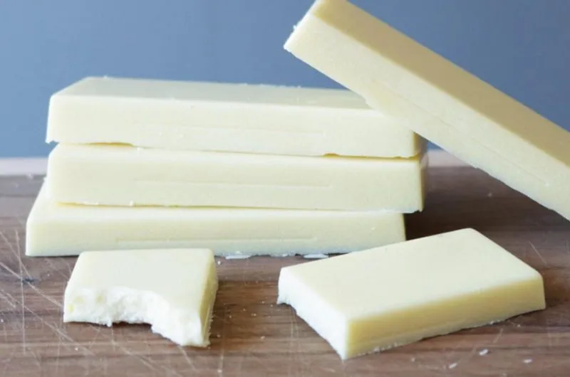 how to make white chocolate with 3 ingredients stacks of white chocolate on cutting board.
