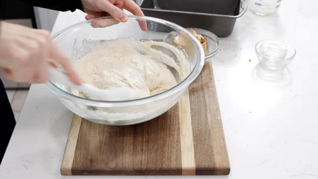 Hand mixing milk into the batter