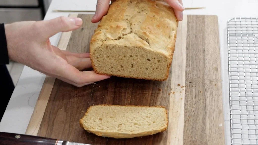 Sliced peanut butter bread on a wooden cutting board.