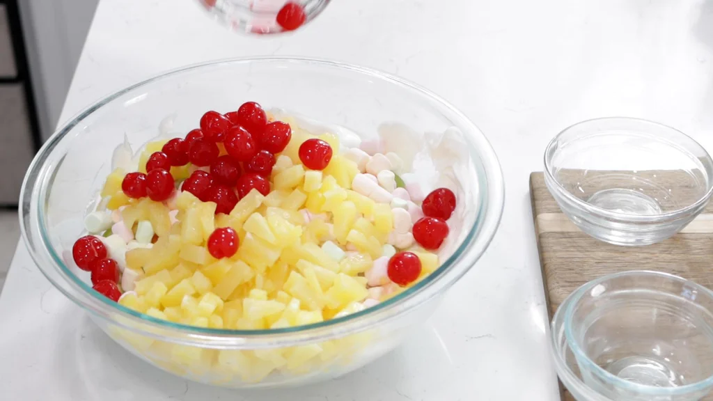 Several ingredients added to the bowl of whipped topping and sour cream.