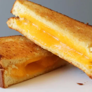air fryer grilled cheese sandwich on a white plate.