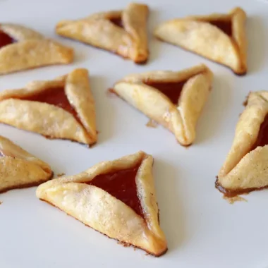 White plate full of hamanstachen pie crust cookies