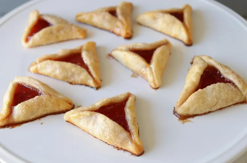 White plate full of hamanstachen pie crust cookies