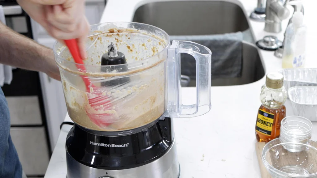 Blended ingredients in a food processor bowl.
