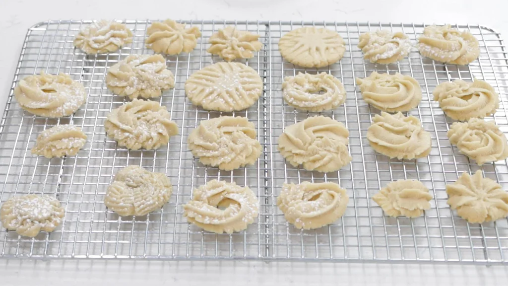 Butter cookies on a wire rack cooling.